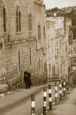 Elderly jewish man climbing to the Old City of Jerusalem clipart