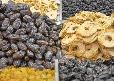 Dates and dried ananas pieces at the arabic market clipart