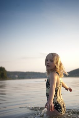 Girl smilimg in lake clipart