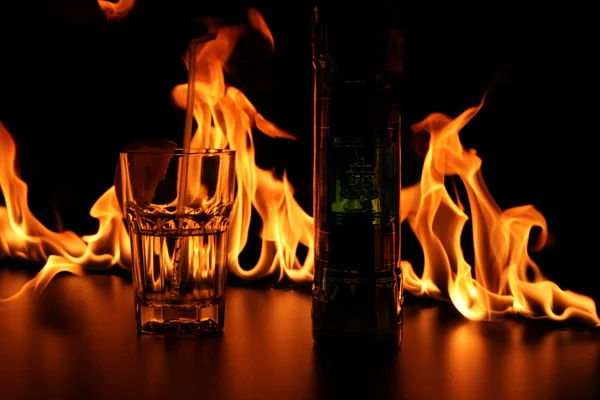 Fireshow on bar rack with glasses and bottle — Stock Photo, Image