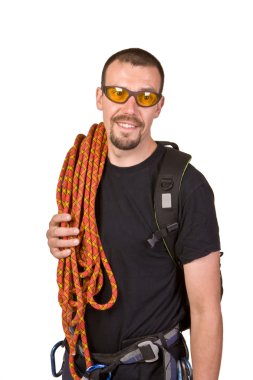 Rock-climber in sun glasses looks in the chamber clipart