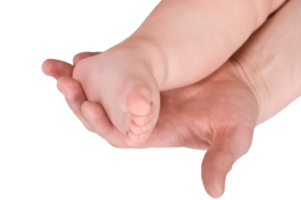Children foot and adult hand — Stock Photo, Image