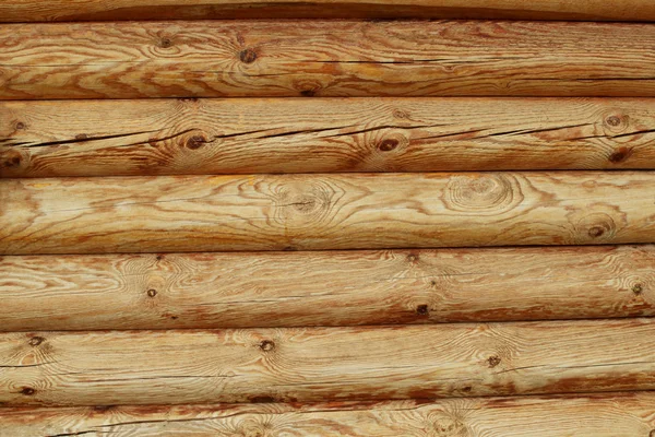 Trä loggar vägg av lantligt hus bakgrund — Stockfoto