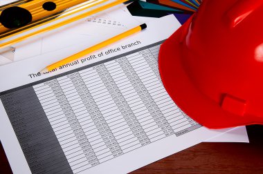 Helmet, level, pencil, briefs on a table clipart