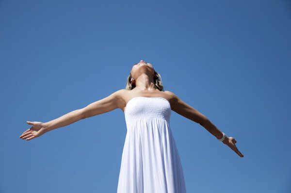 Woman having stretched hands aspires in the sky