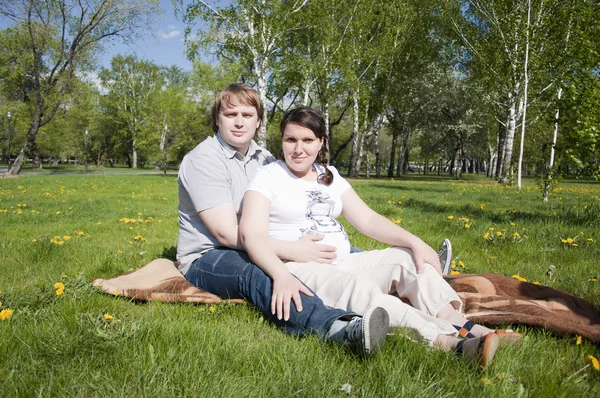 Hombre y mujer embarazada en el parque — Foto de Stock