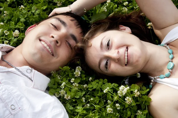 Couple lays together on a grass — Stock Photo, Image