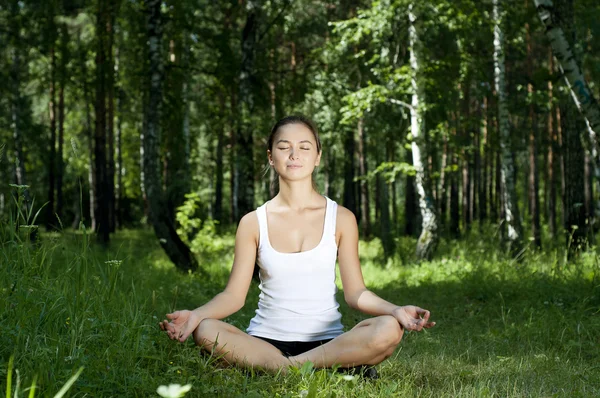 Mulher de ioga na grama verde — Fotografia de Stock