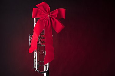 Silver Trumpet with Red Bow on Red clipart