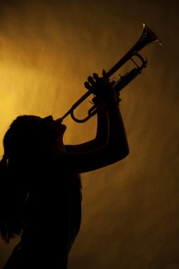Teenage Girl Trumpet Player In Silhouette clipart