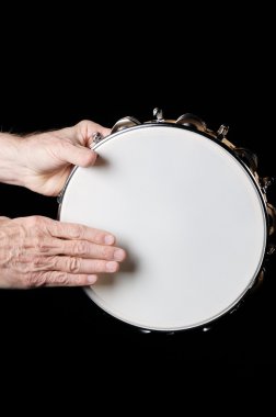 Tambourine and hands Isolated On Black clipart