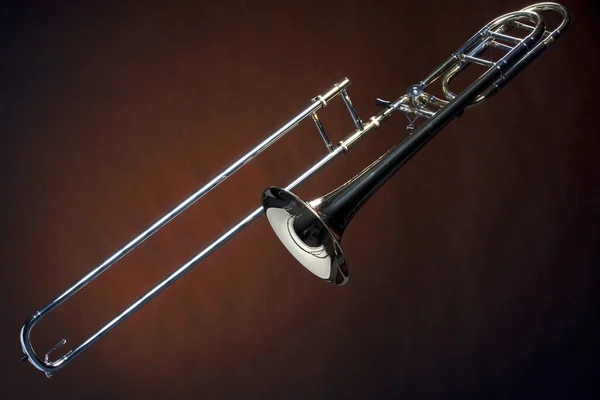 Trombone Isolated Against Gold Spotlight — Stock Photo, Image