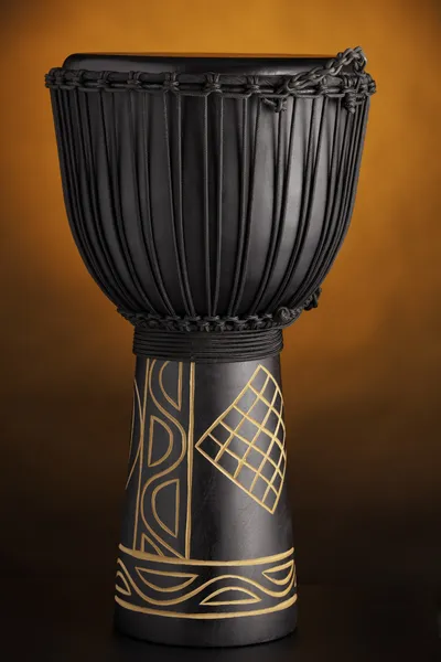 Black Djembe Drum Isolated on Orange Spotlight — Stock Photo, Image