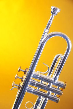 Silver Trumpet Isolated On Yellow Gold clipart