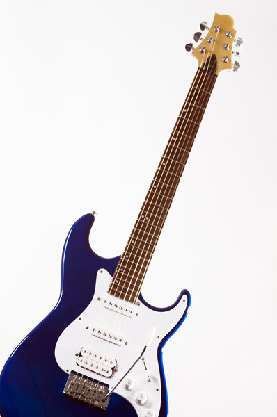 A Metallic blue electric guitar isolated on a high key white background in the vertical format.
