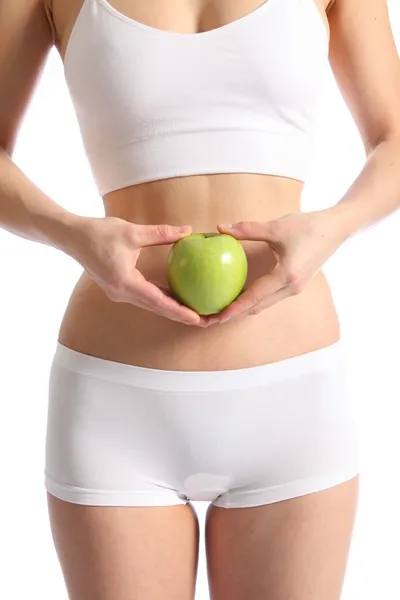 Женское тело в нижнем белье с яблоком — стоковое фото