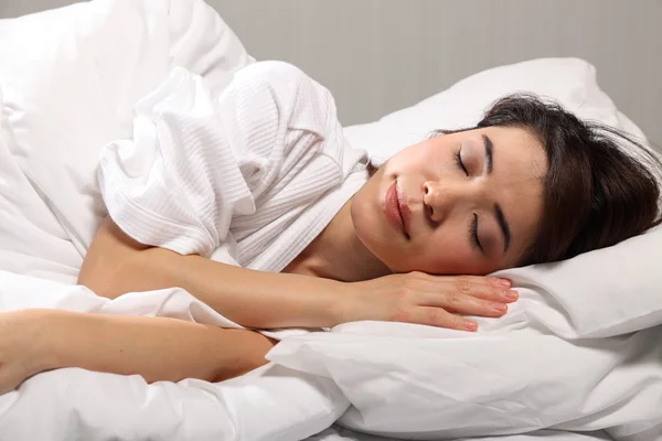 Orientální dívka spí v posteli — Stock fotografie