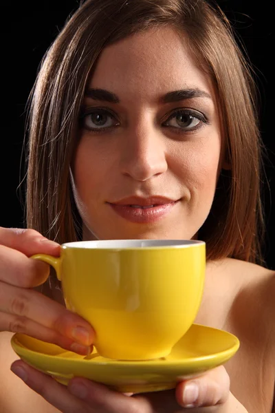 Mulher com xícara de chá amarelo e pires — Fotografia de Stock