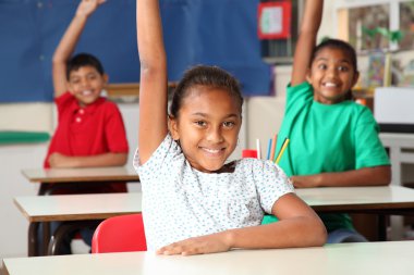 School children arms raised in class clipart