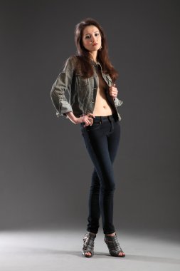 Girl posing in skinny jeans clipart