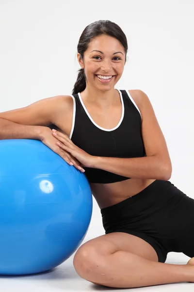 Smiling fitness girl with exercise ball — Stok fotoğraf