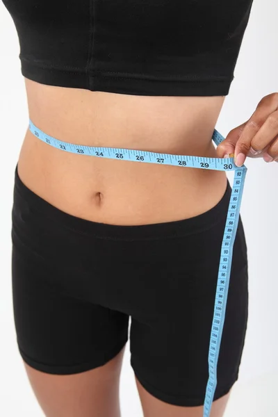 Measuring waist of a slim woman — Stock Photo, Image