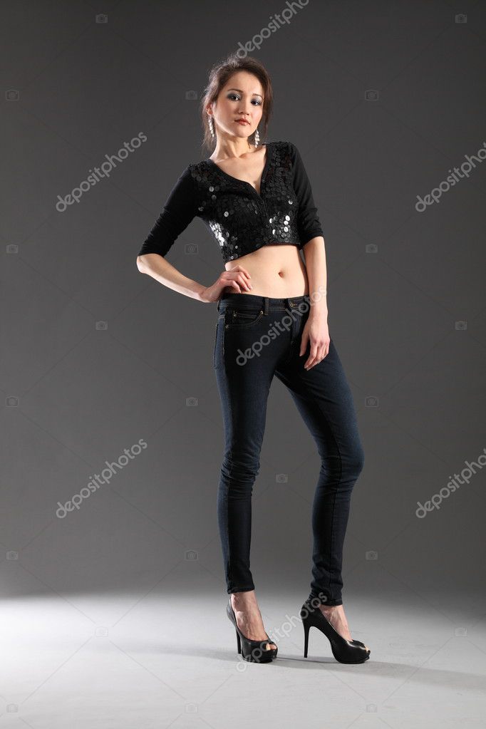 beautiful anorexic woman, standing, grey