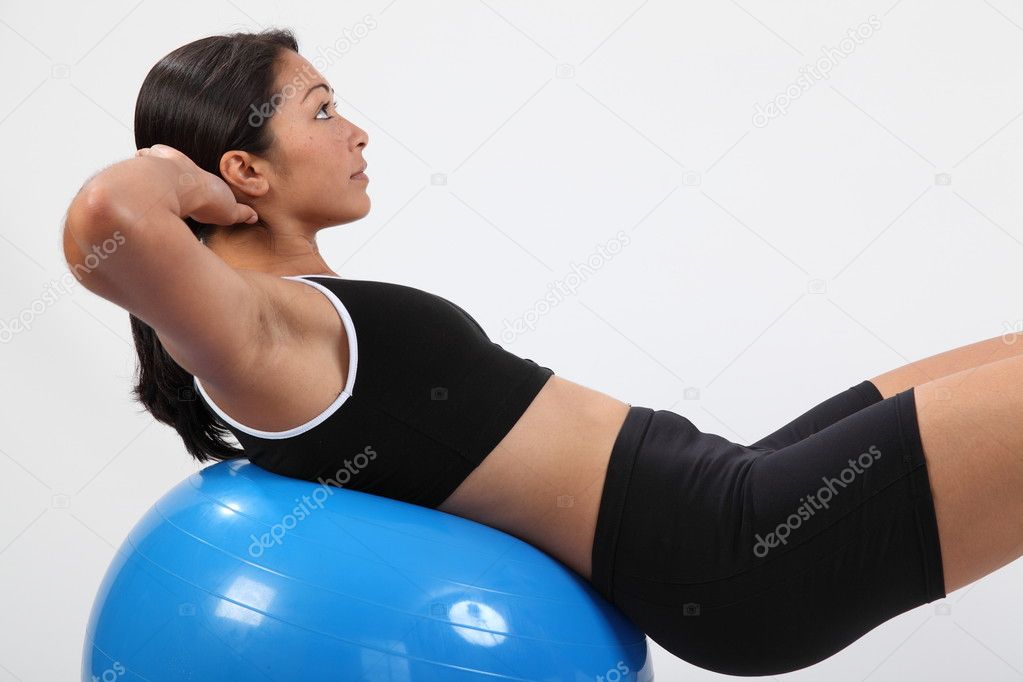 Athletic young sports woman on ball