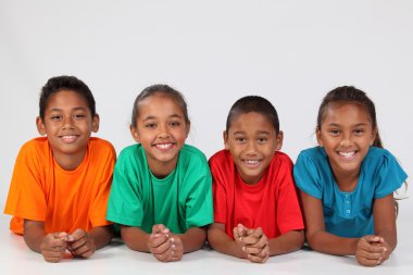 Four young friends lying on floor clipart