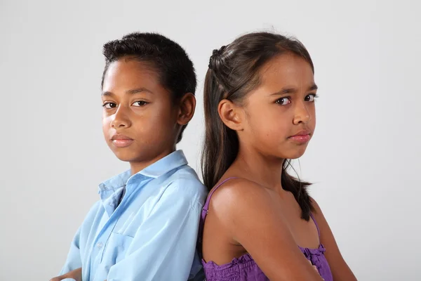 Boy and girl looking serious and mad — Stock Photo, Image
