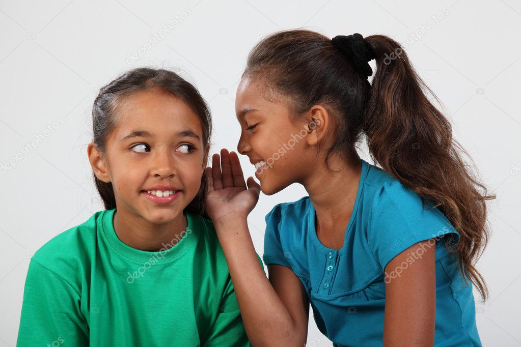 Two girls keeping a secret