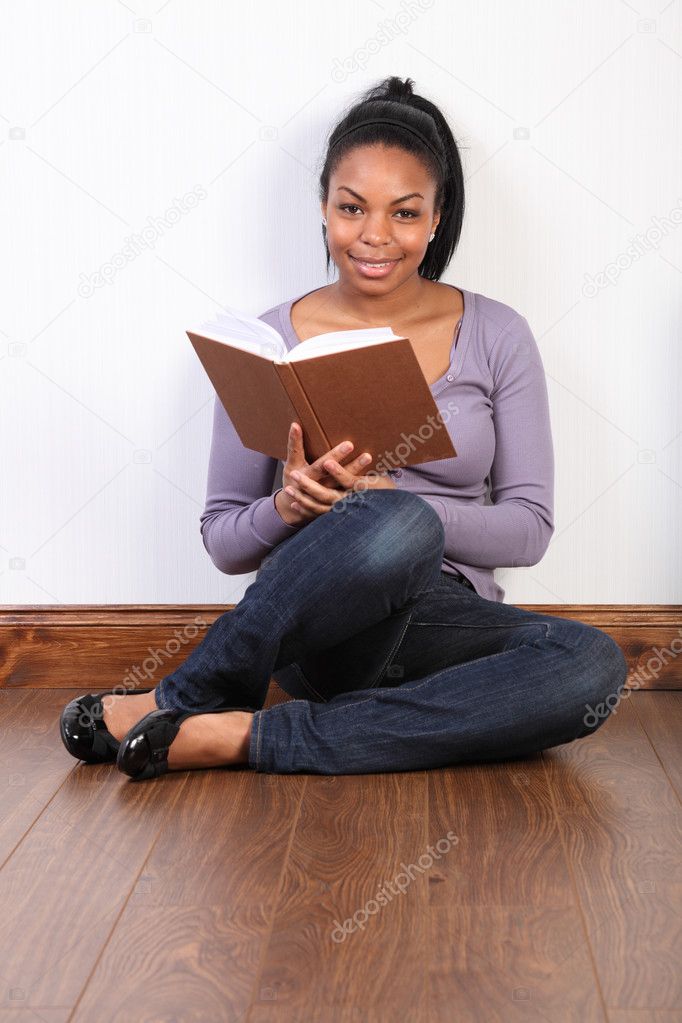 Beautiful african american girl reading a book