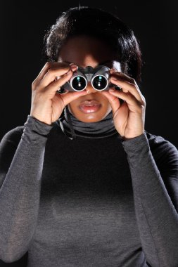 Young woman spy looking through binoculars clipart
