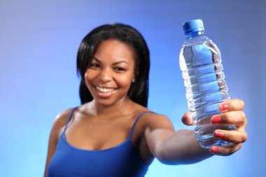 Girl holding out sharply focused bottled water clipart