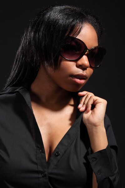 Beautiful black woman in dark sunglasses and shirt