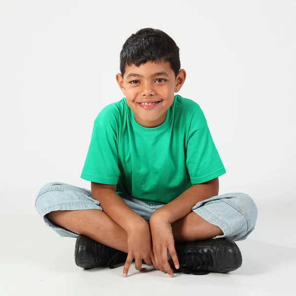 Cute school boy cross legged — Stock Photo, Image