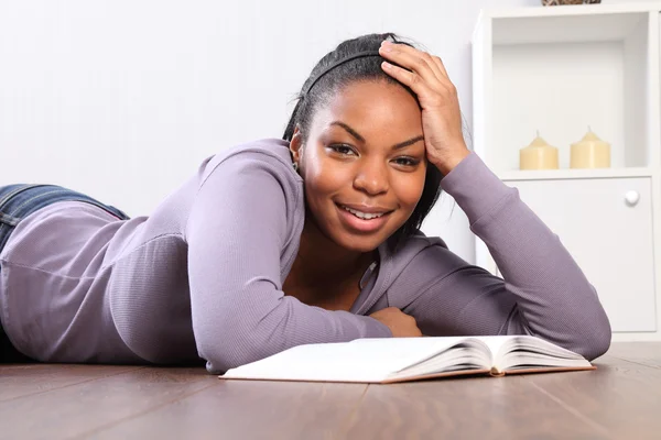 Time out student girl looks up from reading book — Stock Photo, Image
