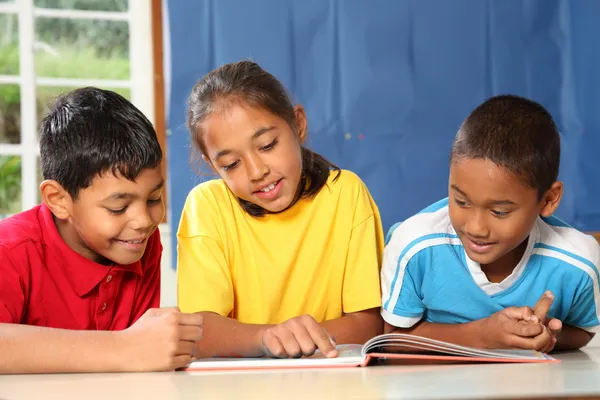 Primary kids learning in classroom Royalty Free Stock Photos