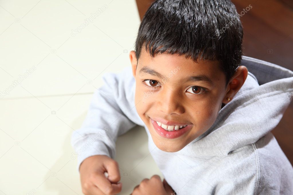 Young happy ethnic boy in class