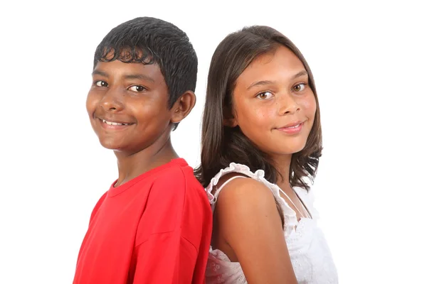 Girl and boy teenagers posing together in studio — Stock Photo, Image