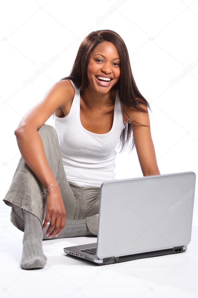 Happy black woman using laptop