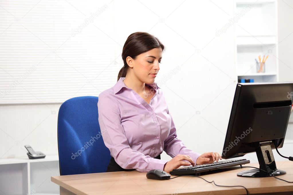 Business woman typing on computer
