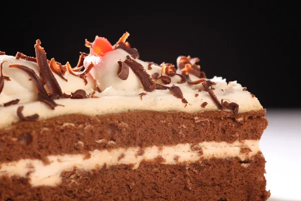 Slice of cream and chocolate cake — Stock Photo, Image