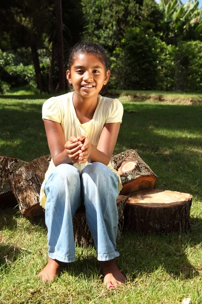 stock image School girl outdoors on logs
