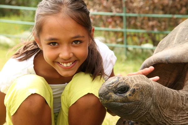 stock image School girl with giant tortoise