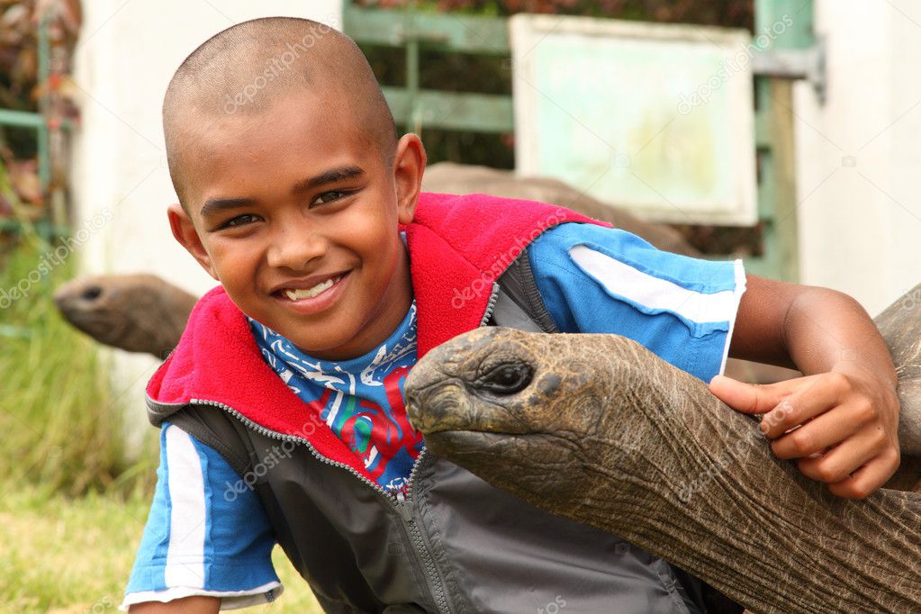 Smiling boy with giant tortoise