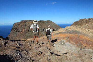 Man and woman hiking in mountain clipart