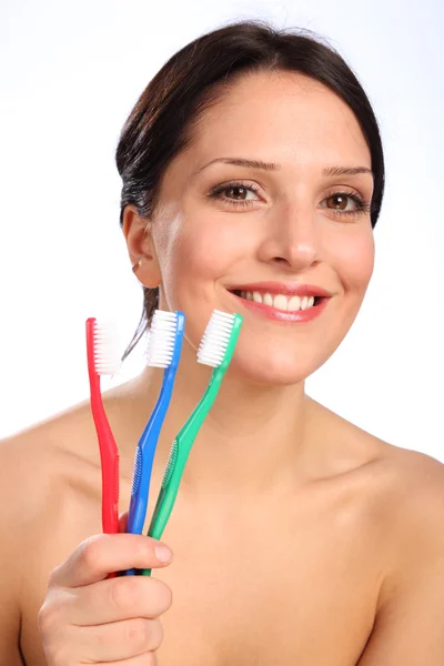 Smiling beautiful young woman with toothbrushes — Stock Photo, Image