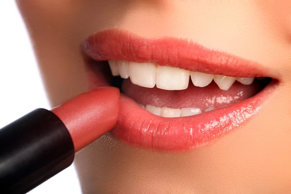 stock image Woman applying lipstick beauty cosmetics to lips