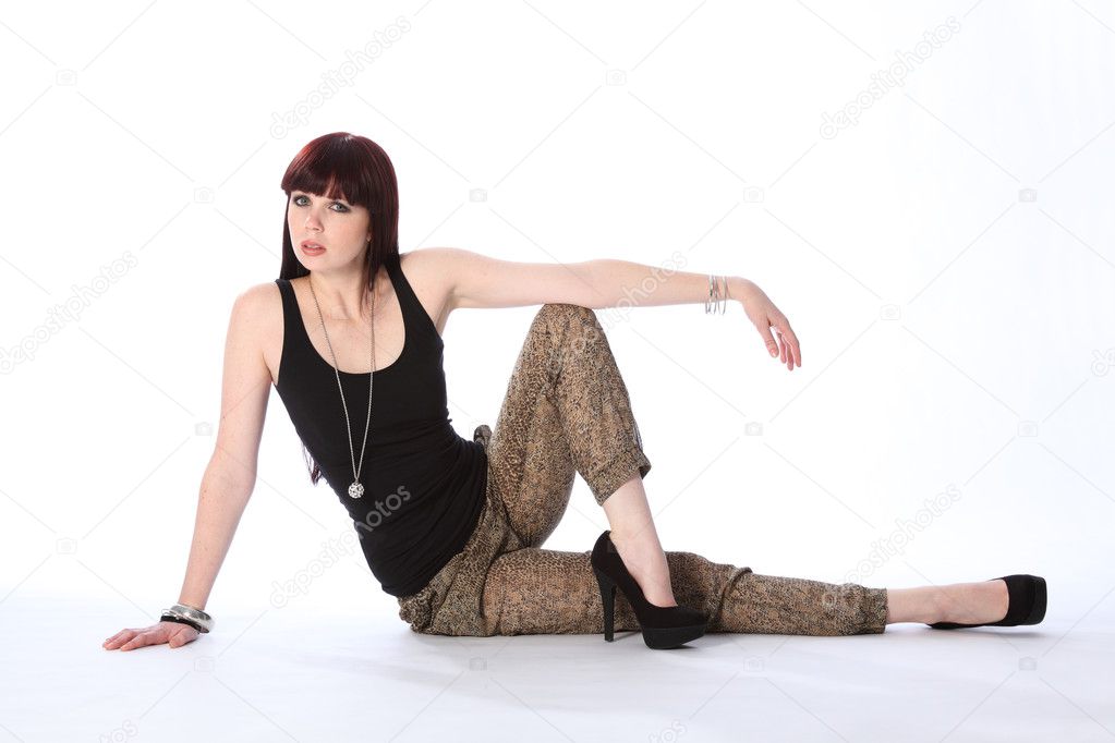 Beautiful young fashion model sitting on floor